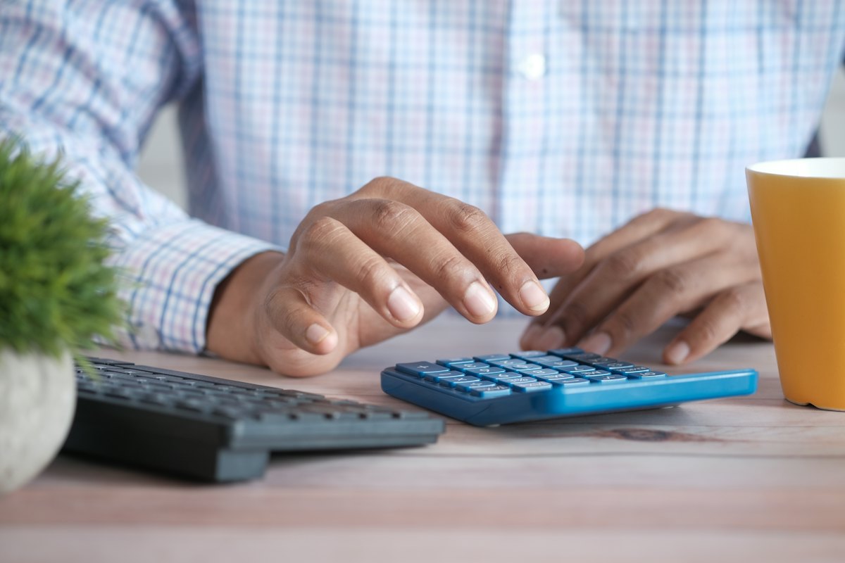 Working with a calculator at a desk