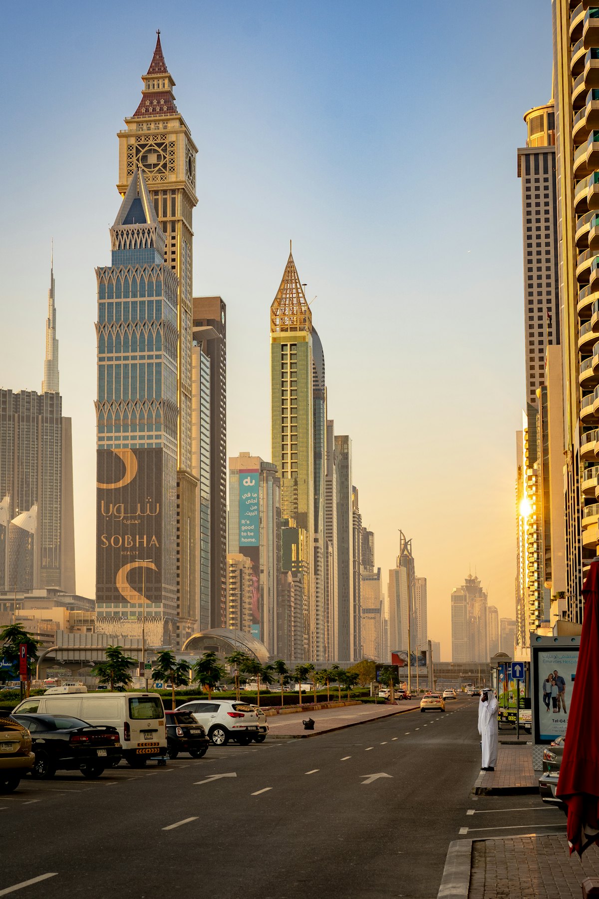 A man walking past towers in Dubai